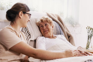 woman sitting and senior in bed