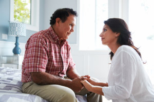 woman holding the hands of senior