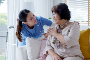 woman holding the shoulder of senior