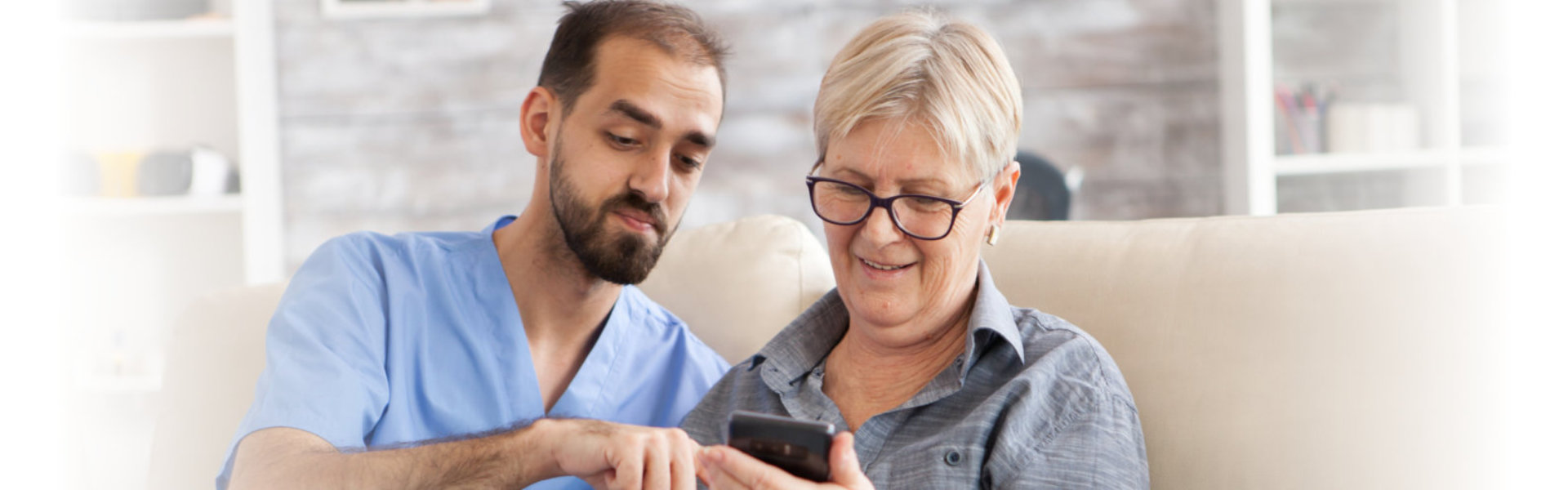 woman and senior looking in phone