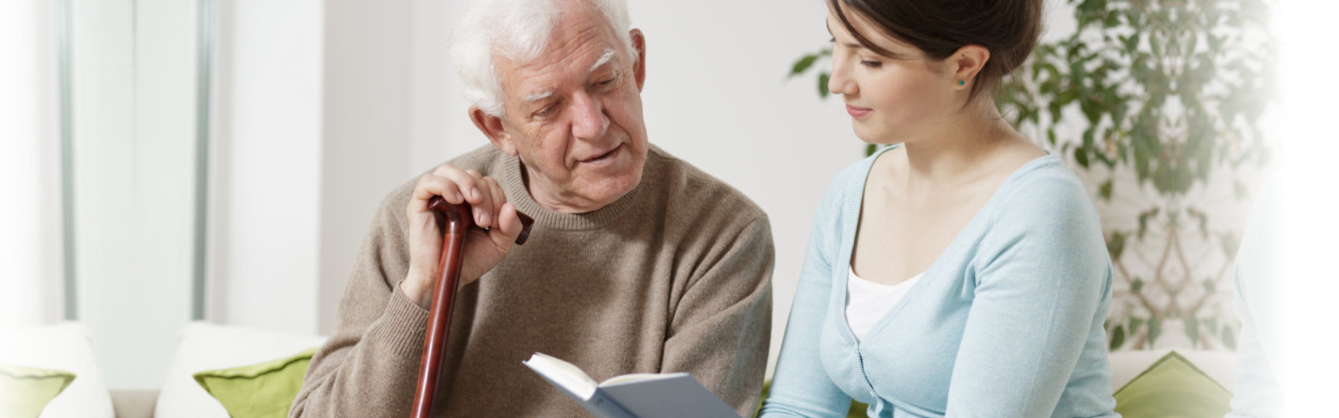 woman and senior looking in notebook